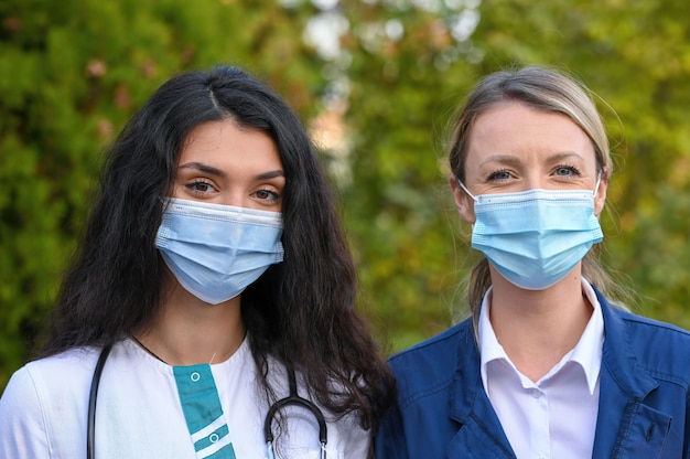 Premium Photo Closeup Focus Shot Of Young Doctors Wearing Face Masks Outdoors 2505