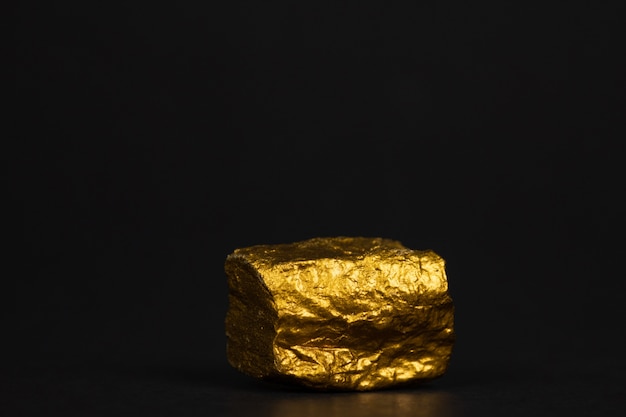 Premium Photo | Closeup of gold nugget or gold ore on black background