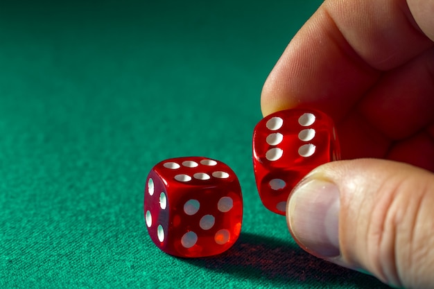 Premium Photo | Closeup of hand holding red dice with a winning ...