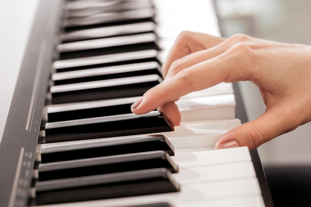 Premium Photo | Closeup of hands playing piano. music and hobby concept