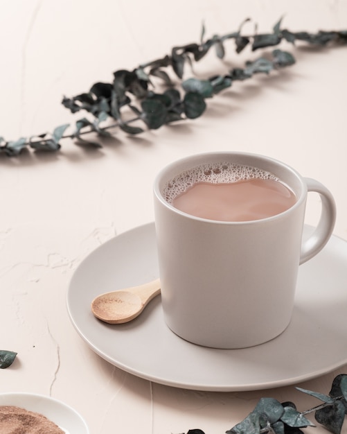Download Free Photo Closeup High Angle Shot Of A Coffee Cup And Some Decorations On White Table PSD Mockup Templates
