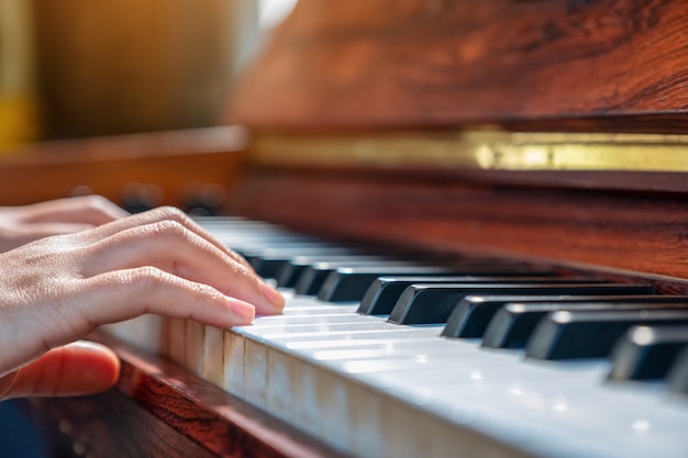 ヴィンテージ木製グランドピアノを弾く手のクローズアップ画像 プレミアム写真