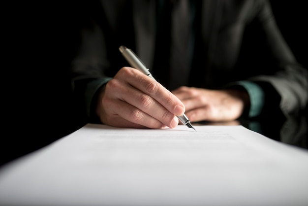 Closeup of lawyer or executive signing a contract Premium Photo