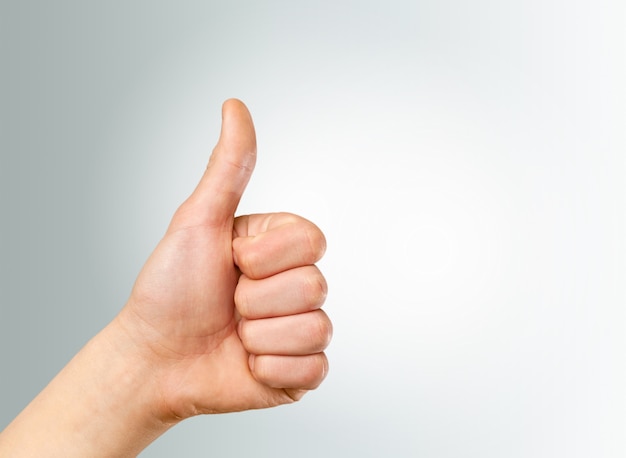 Premium Photo Closeup Of Male Hand Showing Thumbs Up Sign Against