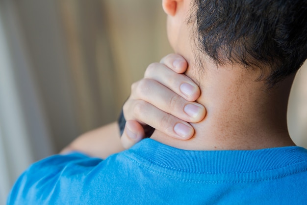 Premium Photo | Closeup of man his neck with hand as he aches with pain ...