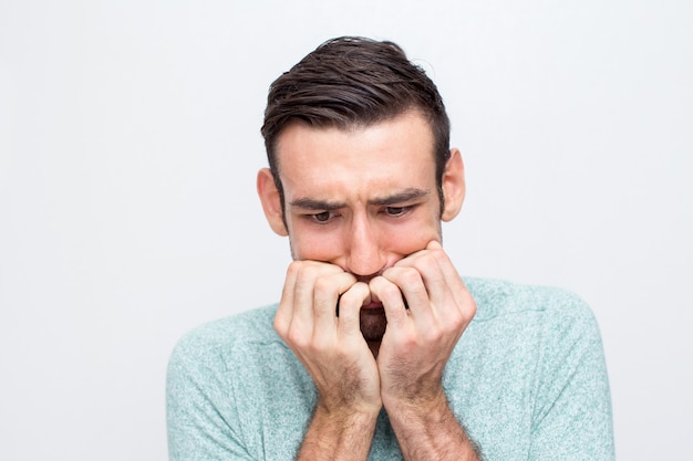 closeup-of-nervous-young-man-biting-nails-photo-free-download