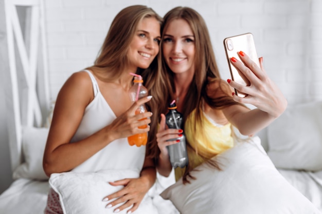 Premium Photo Closeup Of Phone Girls Doing Selfies And Drinking