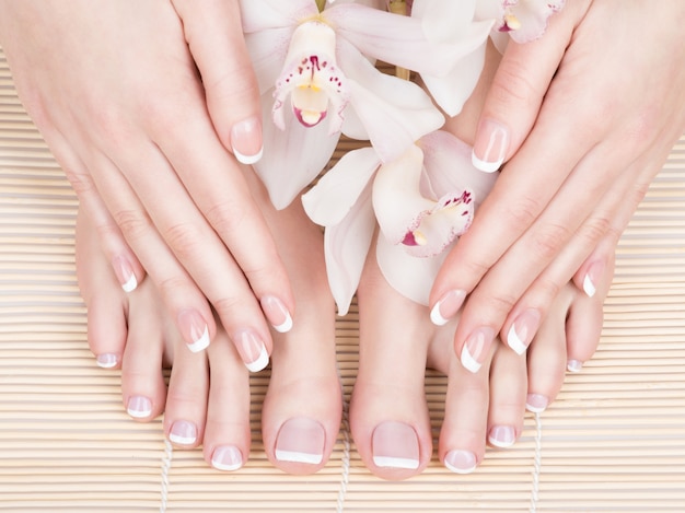 Closeup photo of a female feet at spa salon on pedicure and manicure procedure - soft focus image Free Photo