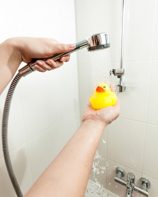 Premium Photo Closeup Photo Of Man Douching Rubber Duck At Shower