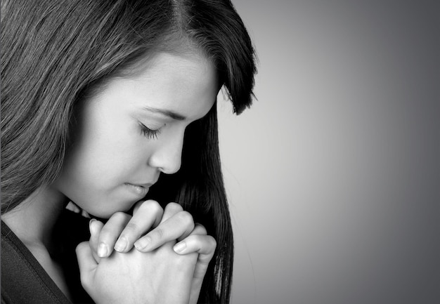 Premium Photo | Closeup portrait of a young woman praying