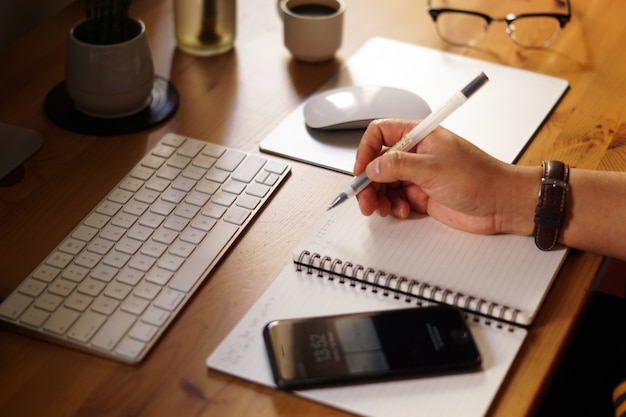 Closeup shot of an entrepreneur working from home and doing calculations Free Photo