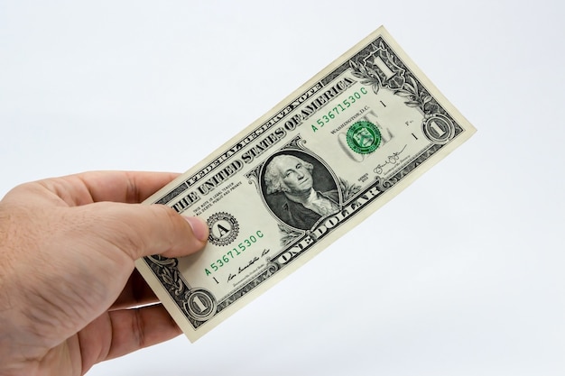 Free Photo | Closeup shot of a person holding a dollar bill