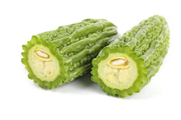 Premium Photo | Closeup shot of sliced green bitter gourds on a white