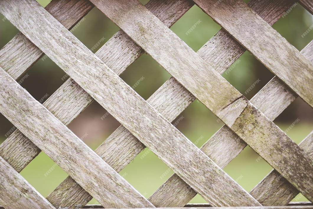 free-photo-closeup-shot-of-a-wooden-criss-cross-fence-with-a-blurred