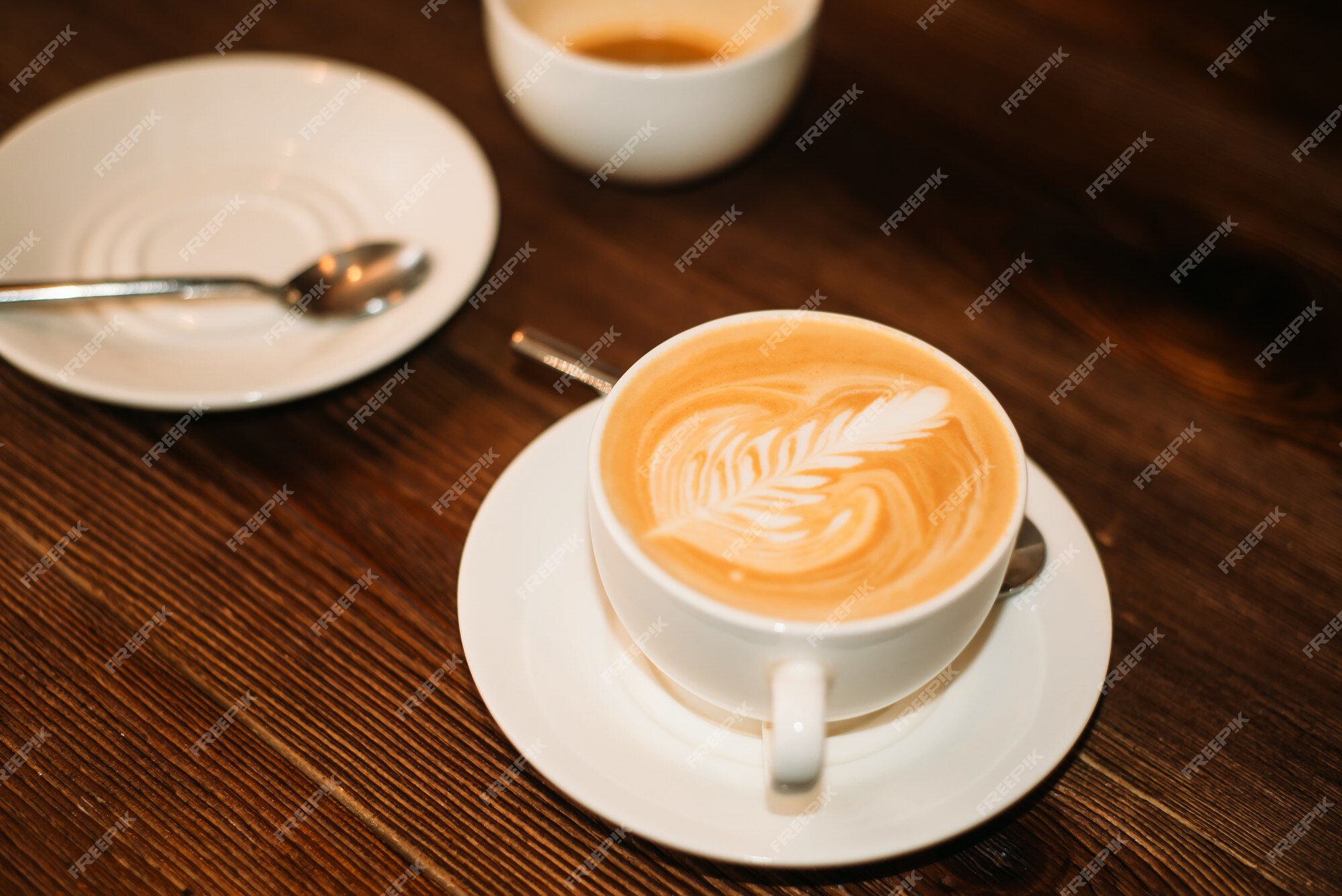 Premium Photo | Closeup two cups of coffee, plate and spoon on wooden ...