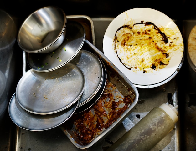 Closeup of used dishes and trays in restaurant kitchen sink | Free ...