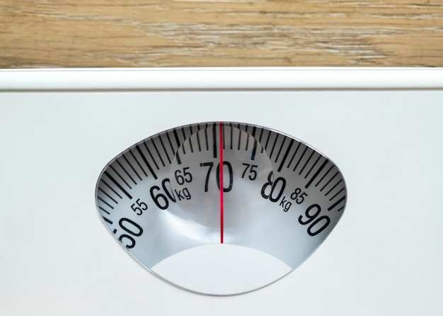 Closeup of weight scales overweight and obesity concept Free Photo