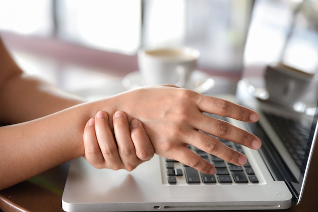 Premium Photo | Closeup woman holding her hand pain from using computer ...