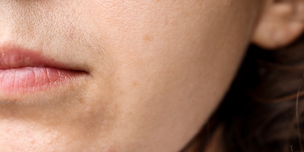 Premium Photo | Closeup of a womans face with a black mustache above ...