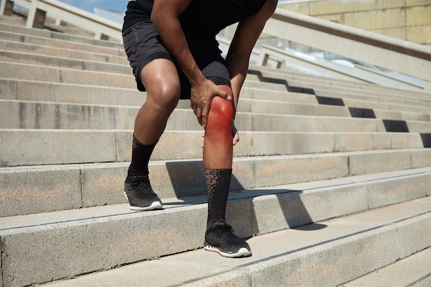Closeup of young man with knee injury Free Photo