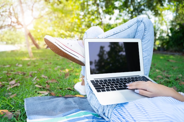 Premium Photo | Closeup of young woman using laptop with relax in garden.