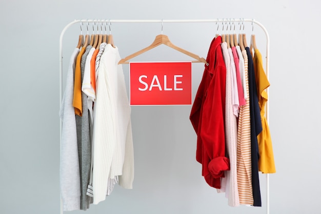 Premium Photo | Clothes on the rail and a sale sign final sale discounts