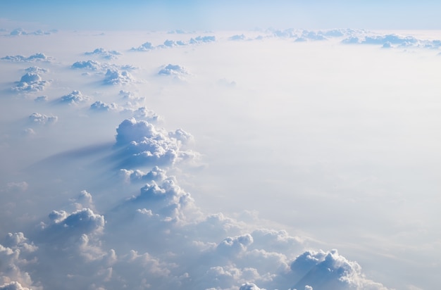 Premium Photo | Clouds in blue sky, aerial view from airplane window.