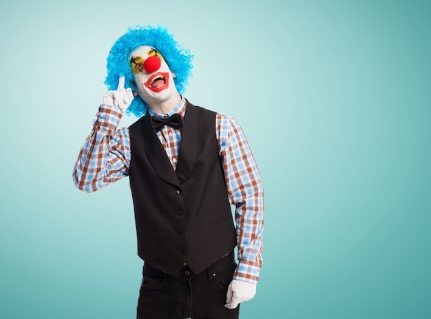 Free Photo | Clown with finger on forehead and smiling