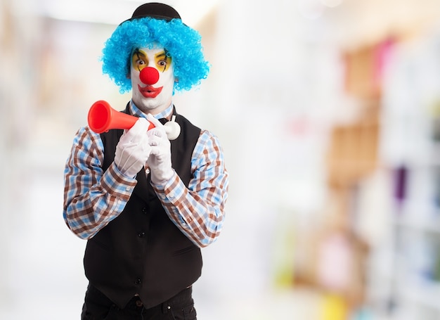 Free Photo | Clown with a red horn