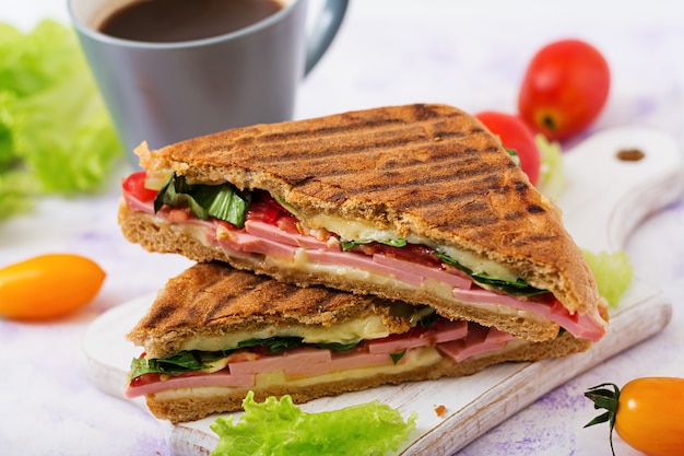 Premium Photo | Club sandwich panini with ham, tomato, cheese and lettuce