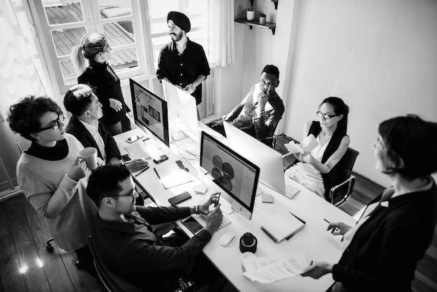 Coworkers Working Together In An Office Premium Photo