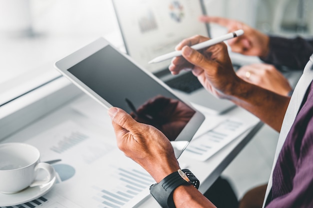 Co-working business team consulting meeting planning with digital tablet strategy analysis investment and saving concept. meeting discussing new plan financial graph data. Premium Photo