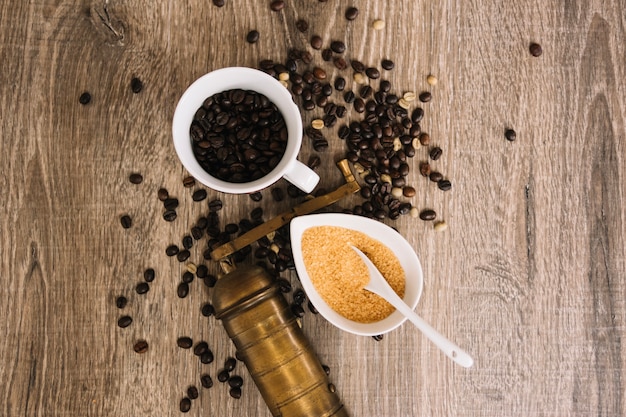 Coffee beans near sugar and grinder | Free Photo