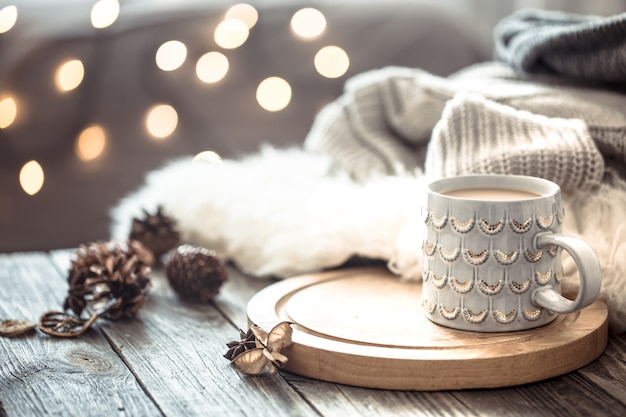 Free Photo Coffee Cup Over Christmas Lights Bokeh In Home On Wooden Table With Sweater On A Wall And Decorations Holiday Decoration