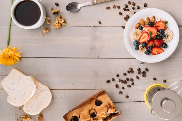 Coffee cup with oatmeal and toasts on wooden table Free Photo