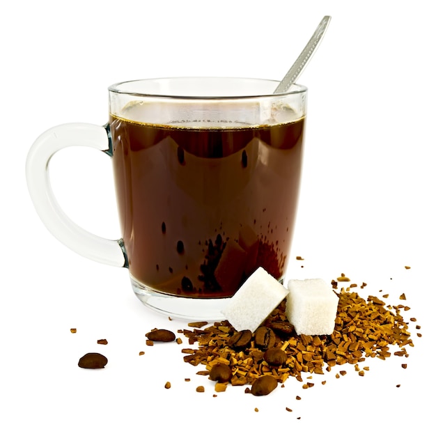 Premium Photo | Coffee in a glass mug, a spoon, grains and granules of ...