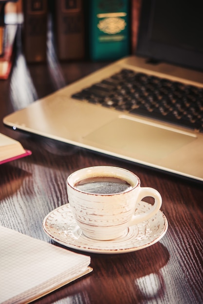 Premium Photo | Coffee morning in the workplace. with a book or laptop ...