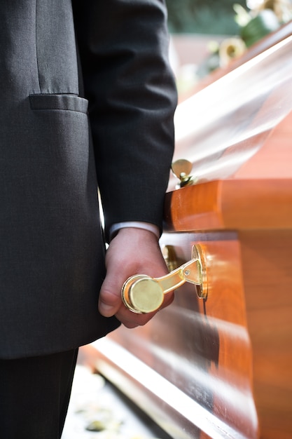 Premium Photo | Coffin bearer carrying casket at funeral