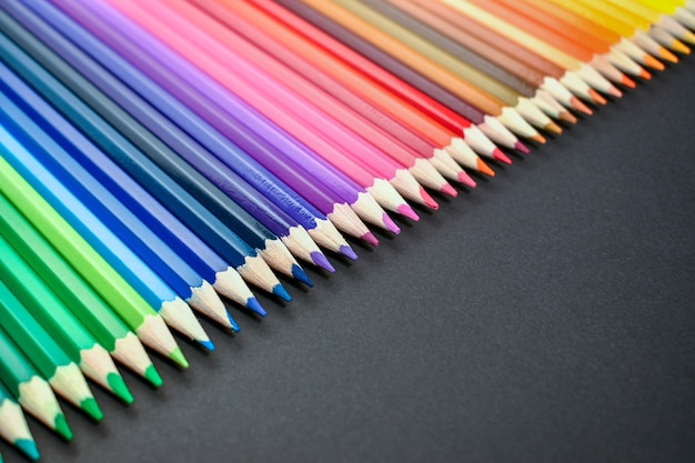 Premium Photo | Collection of colored pencils on black background