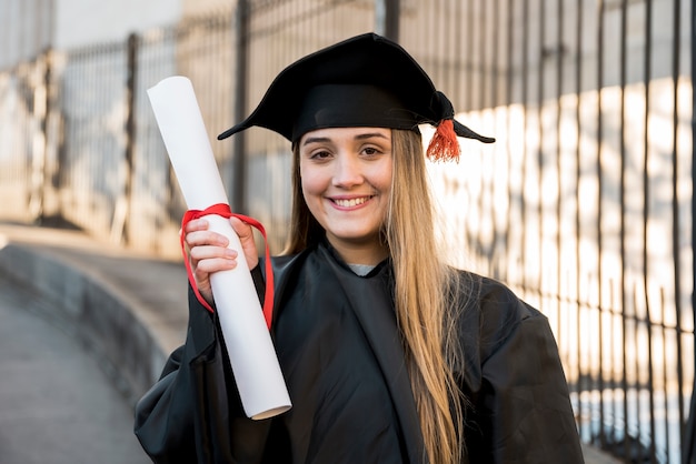Free Photo | College graduate holding her certificate