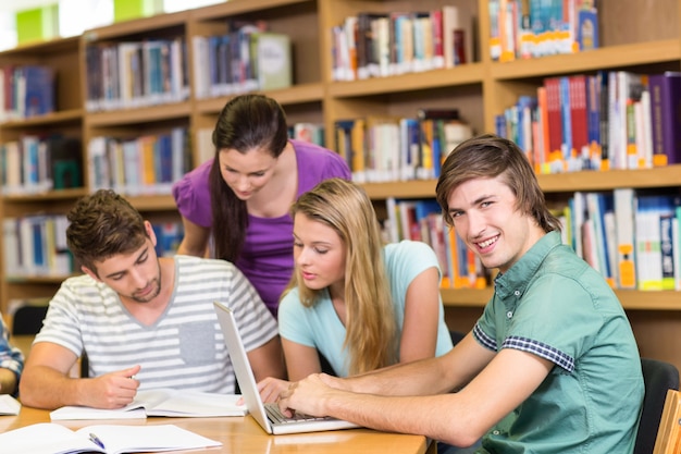 Premium Photo | College students doing homework in library