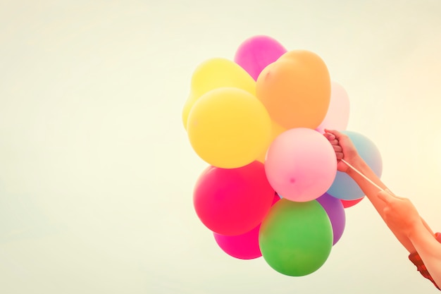 Colored balloons held by arms Free Photo Colored balloons held by arms Free Photo