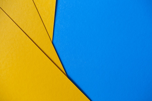 色の幾何学的な青と黄色の紙のテクスチャ背景 無料の写真