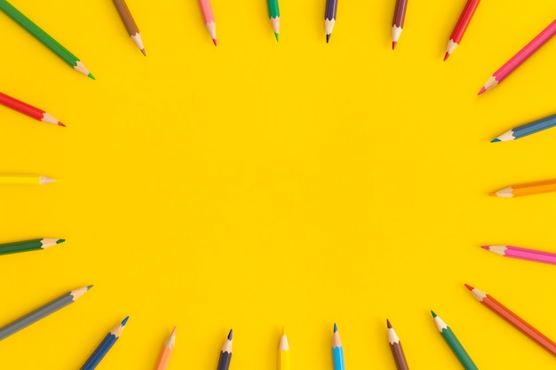 Premium Photo | Colored pencils on yellow background