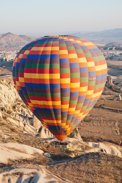 Premium Photo | Colorful balloons flying over mountains and with blue sky