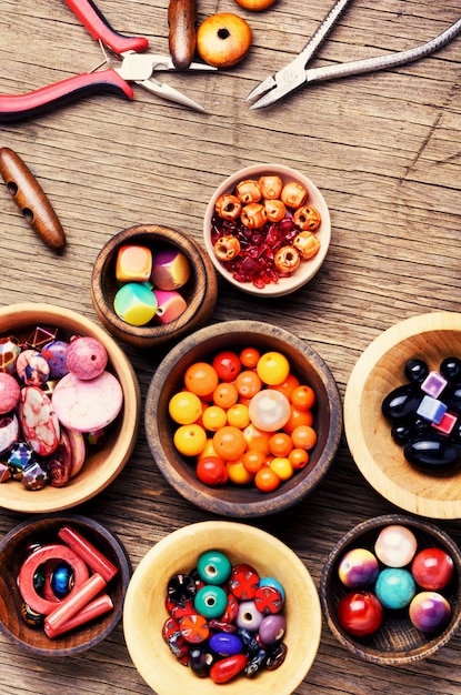 Premium Photo | Colorful beads in wooden bowls