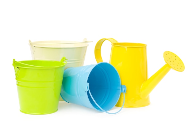 Premium Photo | Colorful buckets and watering can isolated.