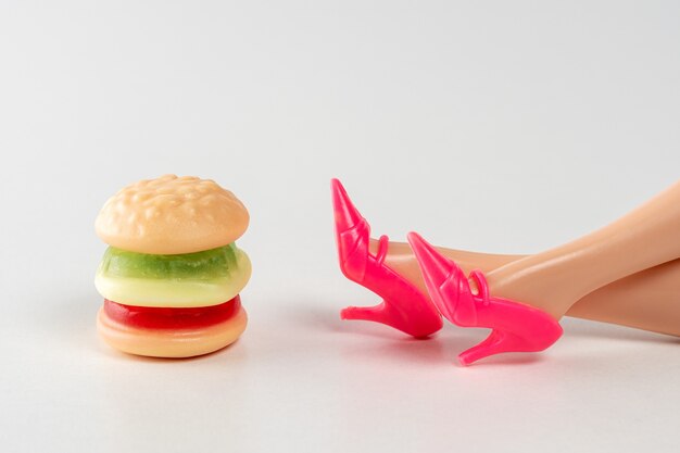 Premium Photo Colorful Candy Hamburger With A Legs Of Doll