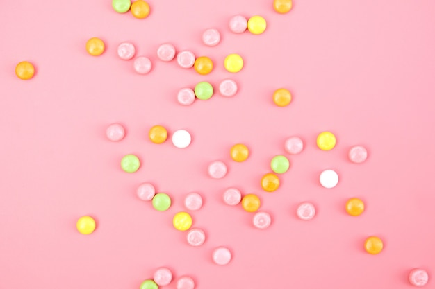 Premium Photo | Colorful candy on pink background