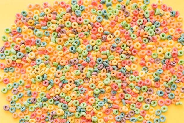 Free Photo | Colorful cereal loop rings on yellow backdrop